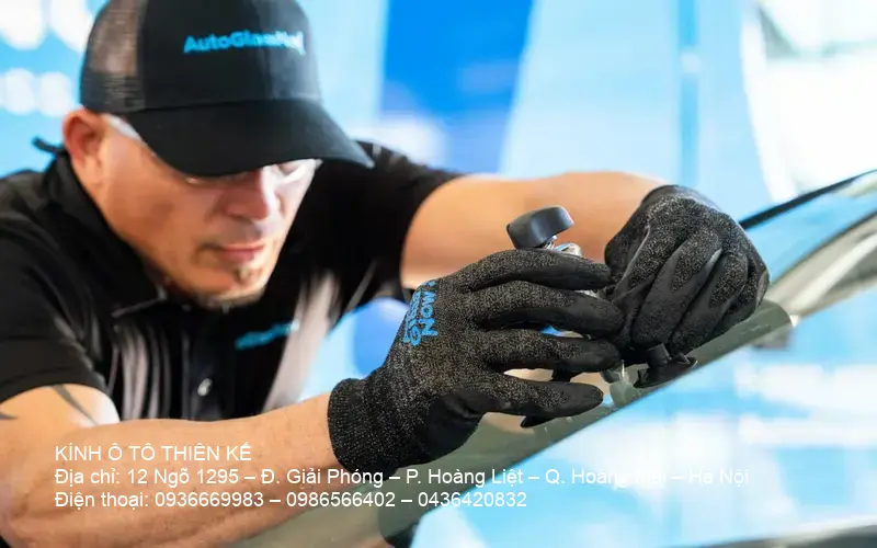 Technician repairing car windshield Technician repairing car windshield