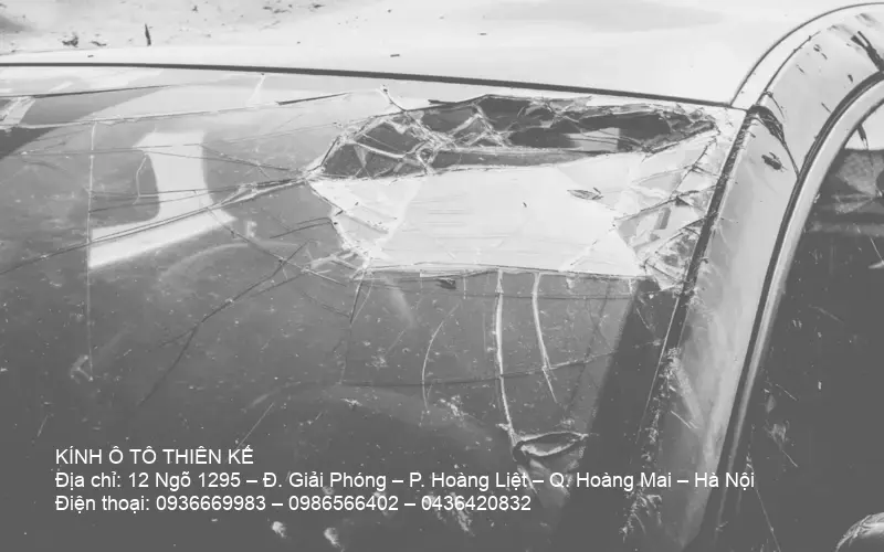 Technician handling auto glass in workshop