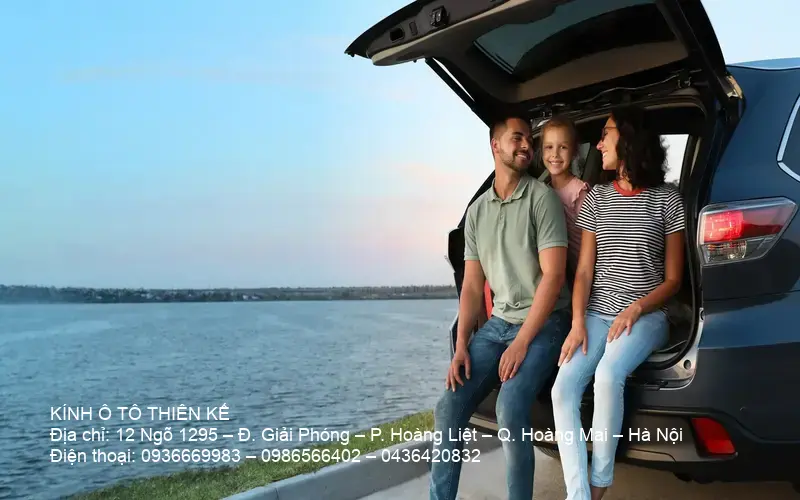 Smiling family inside a car, satisfied after using dịch vụ kính ô tô giá rẻ Hà Nội