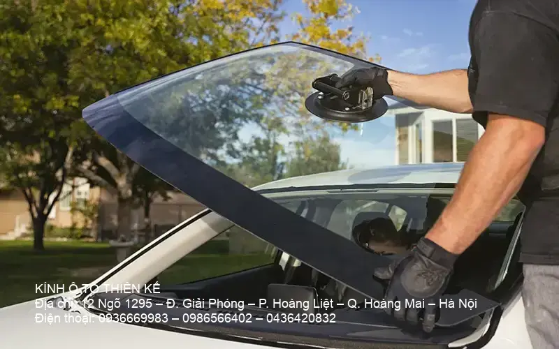 Technician replacing a car windshield