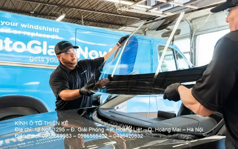 Professional technician replacing car windshield, emphasizing quality work