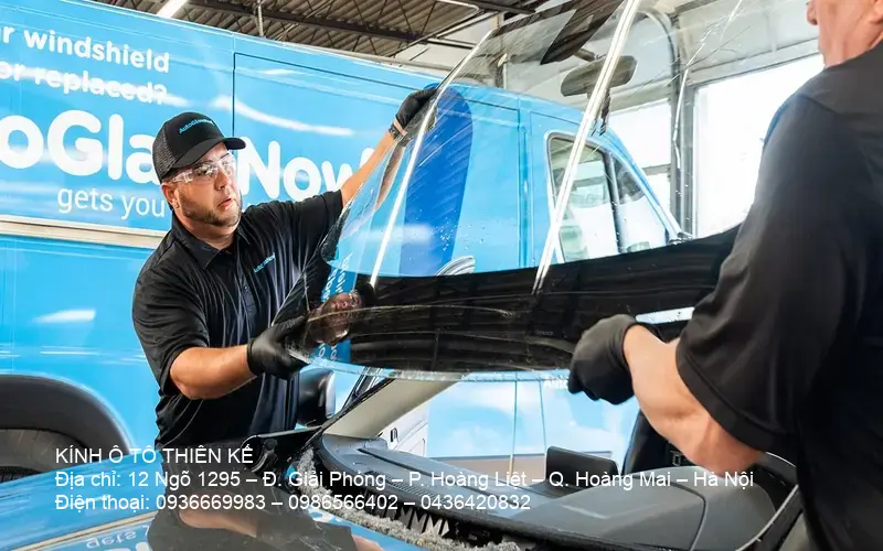 Technician replaces broken windshield